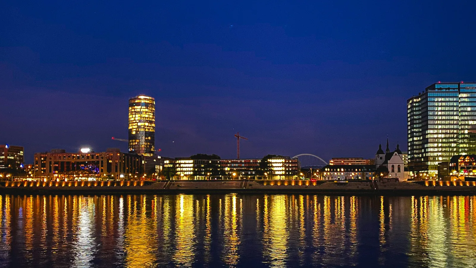 Cologne at night: the Rhine embankment with illuminated office towers